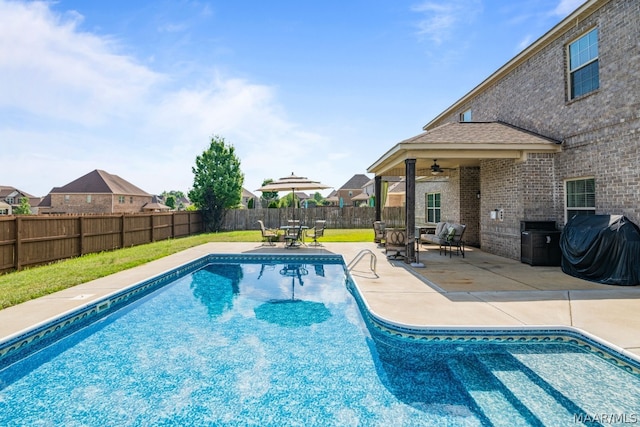 view of pool with a patio, ceiling fan, and a grill