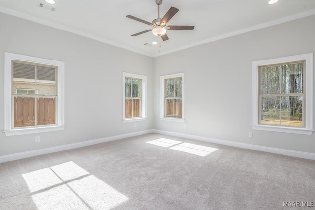 unfurnished room featuring baseboards, light carpet, visible vents, and crown molding