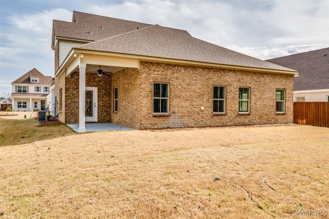 back of property featuring ceiling fan, a patio, brick siding, fence, and roof with shingles