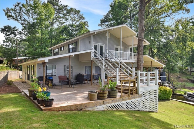 rear view of house with a yard and a deck