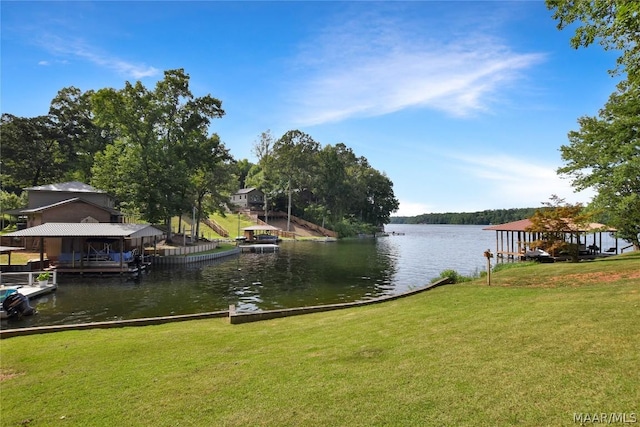 view of dock featuring a lawn and a water view