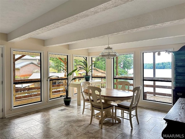 sunroom / solarium with a notable chandelier