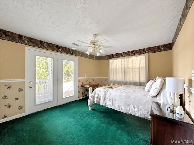 bedroom featuring dark colored carpet, a textured ceiling, access to outside, and ceiling fan