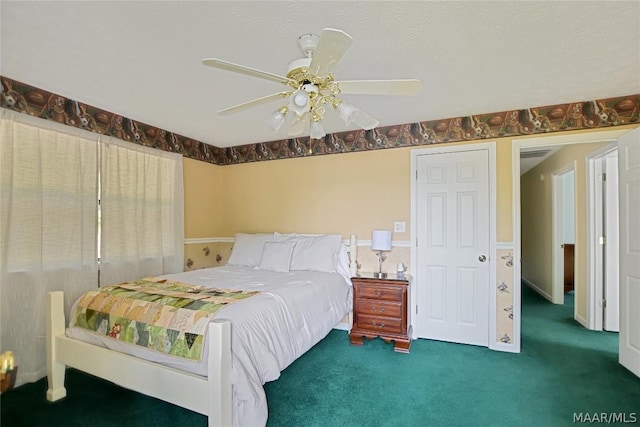 bedroom featuring dark colored carpet and ceiling fan