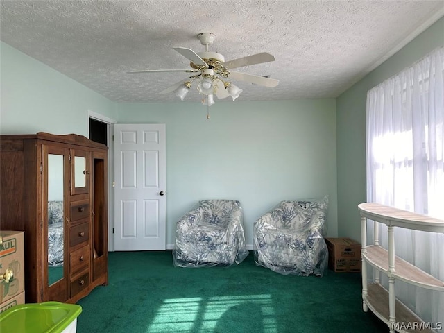 unfurnished room with dark colored carpet, a textured ceiling, and ceiling fan