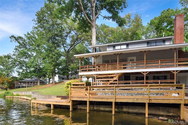 back of property with a water view