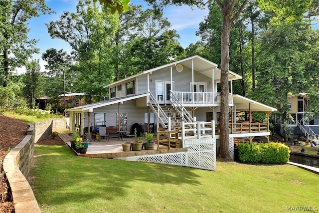 back of house featuring a patio and a lawn