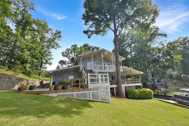 rear view of house with a yard and a deck