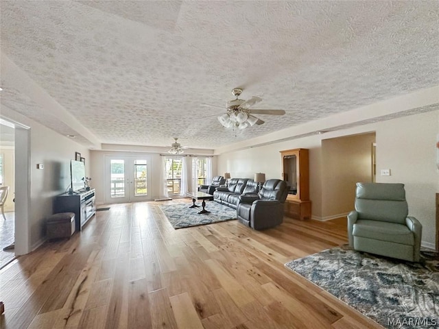 living room featuring ceiling fan and hardwood / wood-style flooring