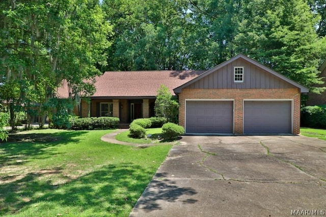 single story home with a front yard, brick siding, driveway, and an attached garage