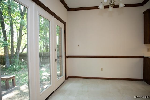 doorway featuring crown molding and baseboards