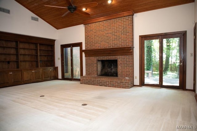 unfurnished living room featuring wooden ceiling, a brick fireplace, visible vents, and light colored carpet