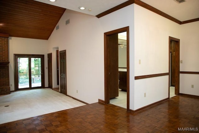 empty room with a brick fireplace, baseboards, visible vents, and high vaulted ceiling