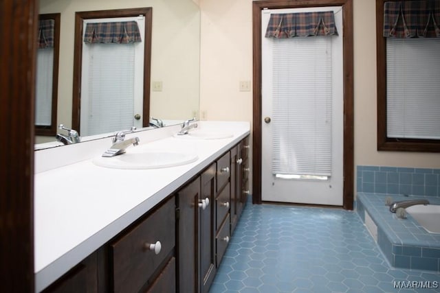 full bath with a garden tub, double vanity, and a sink