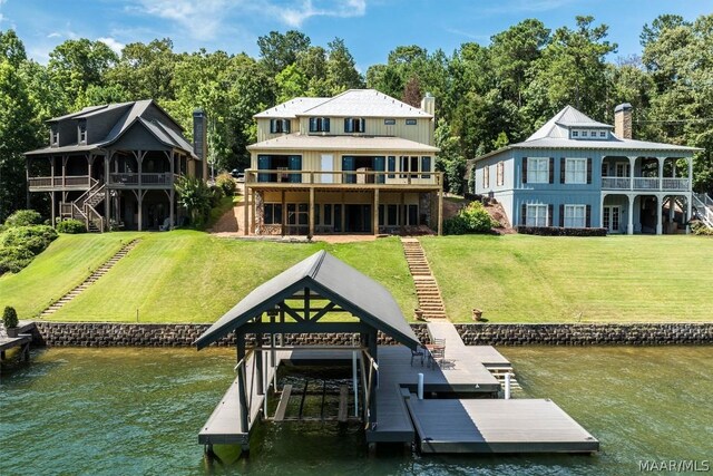 view of dock featuring a water view and a yard