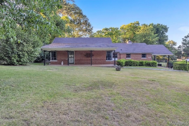 rear view of house featuring a yard