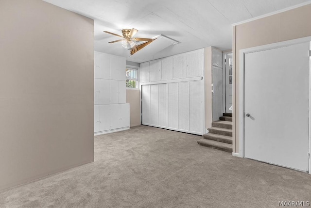 carpeted spare room featuring ceiling fan