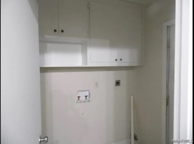 clothes washing area with electric dryer hookup, hookup for a washing machine, and cabinets