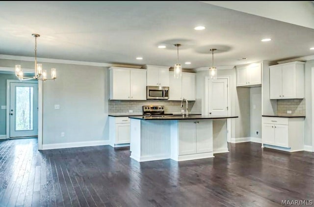 kitchen with dark wood-type flooring, appliances with stainless steel finishes, white cabinets, backsplash, and pendant lighting