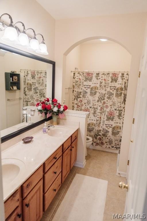 bathroom featuring toilet, vanity, and tile patterned floors