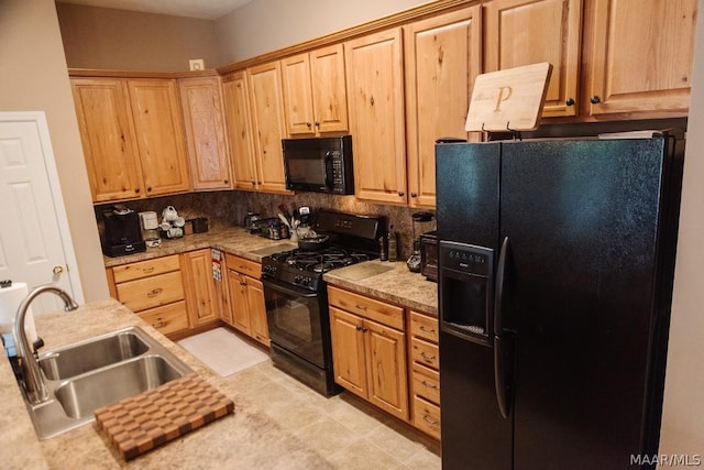 kitchen with light tile patterned floors, sink, tasteful backsplash, and black appliances