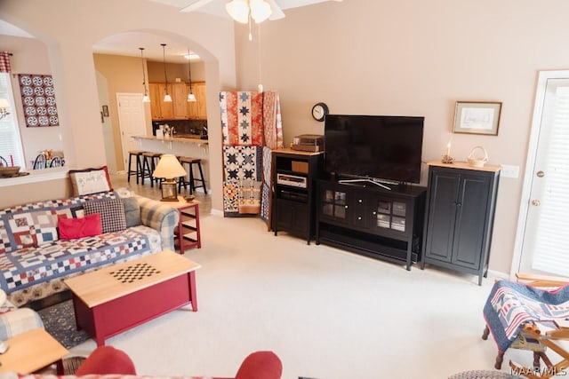 carpeted living room featuring ceiling fan