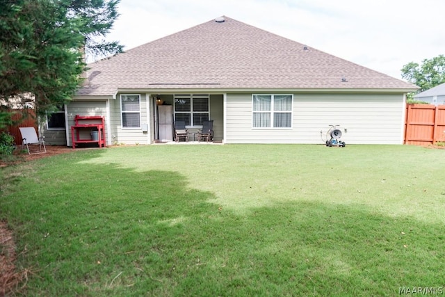 back of house featuring a lawn