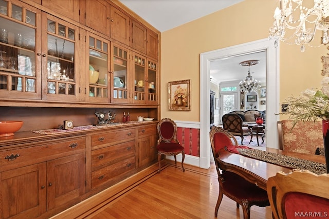 dining room featuring light hardwood / wood-style flooring and a notable chandelier