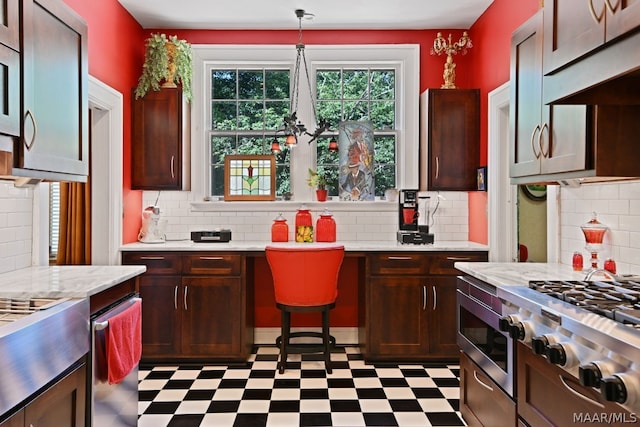 kitchen featuring cooktop, backsplash, decorative light fixtures, and built in microwave