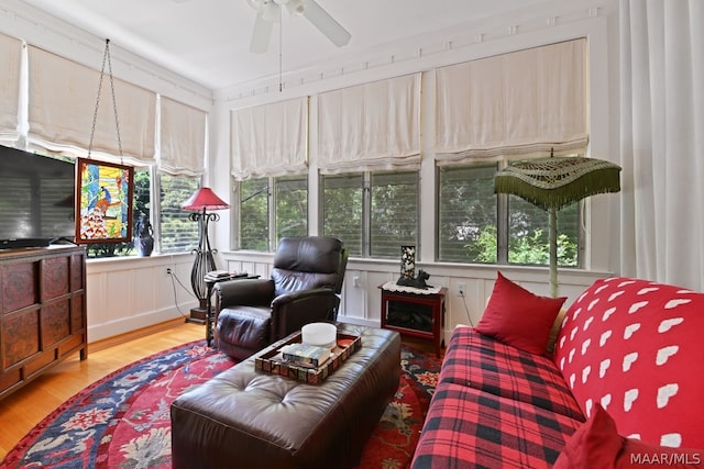 sunroom / solarium featuring ceiling fan