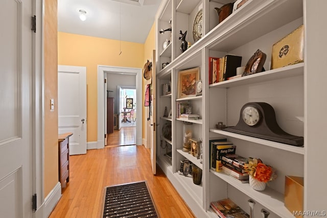 hallway with light hardwood / wood-style flooring