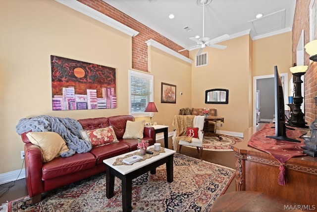 living room featuring ceiling fan and ornamental molding