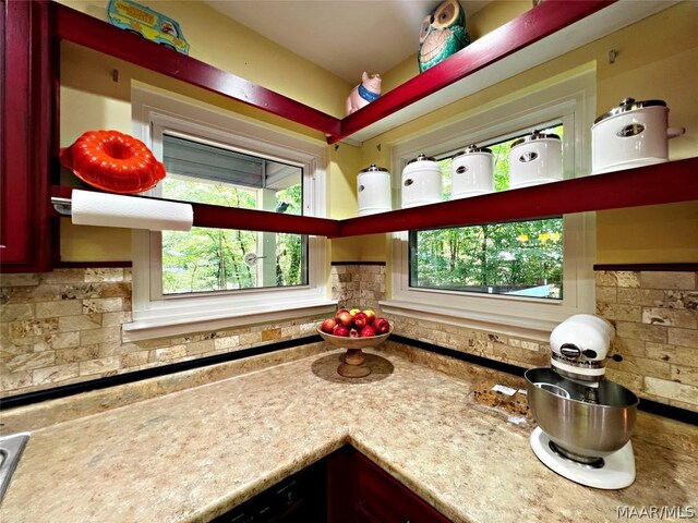 kitchen featuring light stone countertops and tasteful backsplash