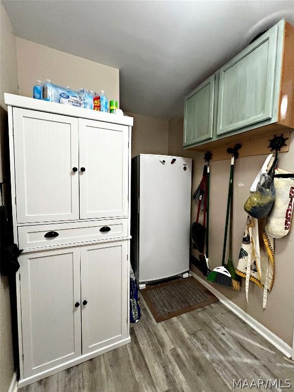 laundry area with hardwood / wood-style floors