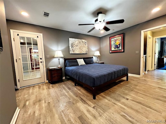 bedroom featuring light wood finished floors, a ceiling fan, visible vents, and baseboards