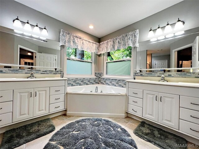 bathroom featuring tile flooring, vanity, and a bathing tub