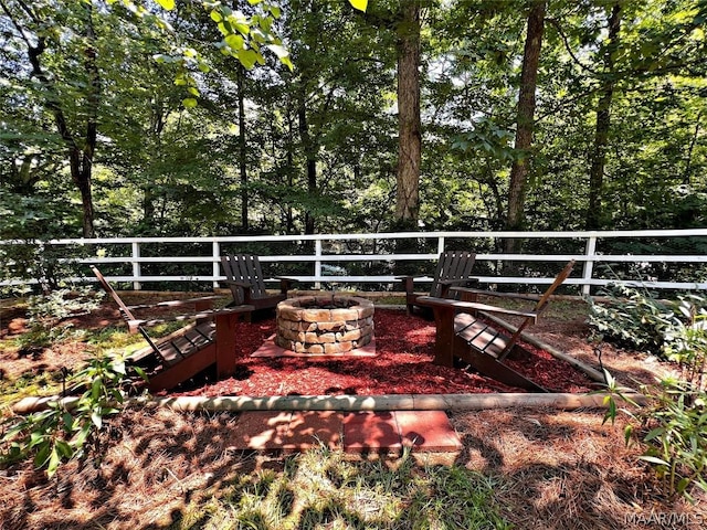 view of yard featuring a fire pit and fence