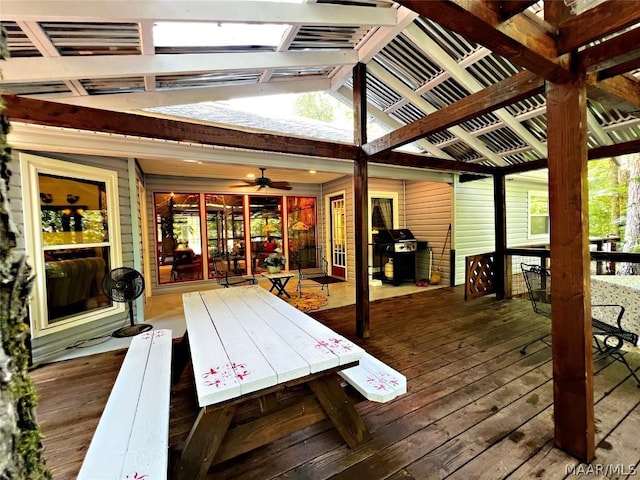 wooden deck with ceiling fan, a pergola, and area for grilling