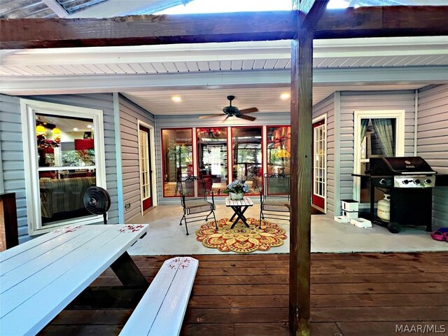 wooden terrace with ceiling fan and area for grilling