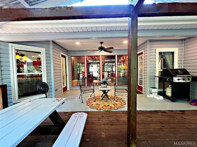 wooden deck featuring ceiling fan and a grill