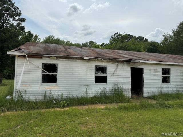 view of side of property with a yard