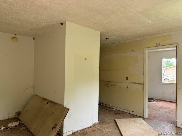 unfurnished room with a textured ceiling