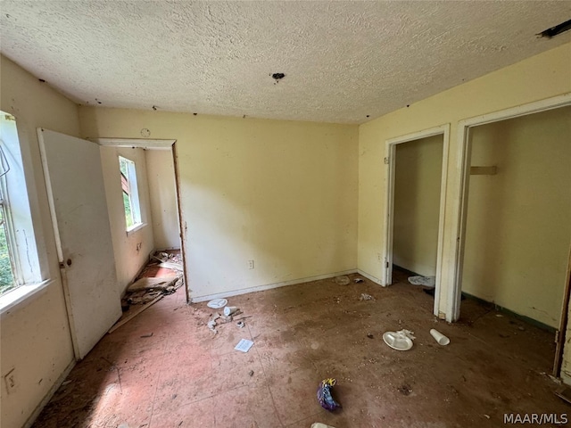 unfurnished bedroom with a textured ceiling