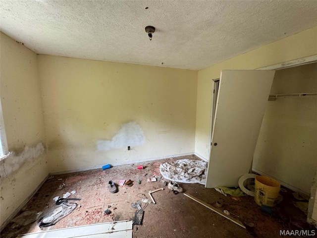 unfurnished bedroom with a textured ceiling