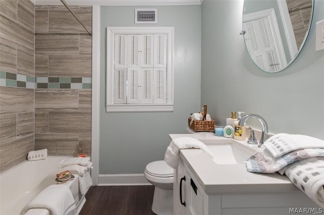 full bathroom with hardwood / wood-style flooring, vanity, toilet, and tiled shower / bath combo