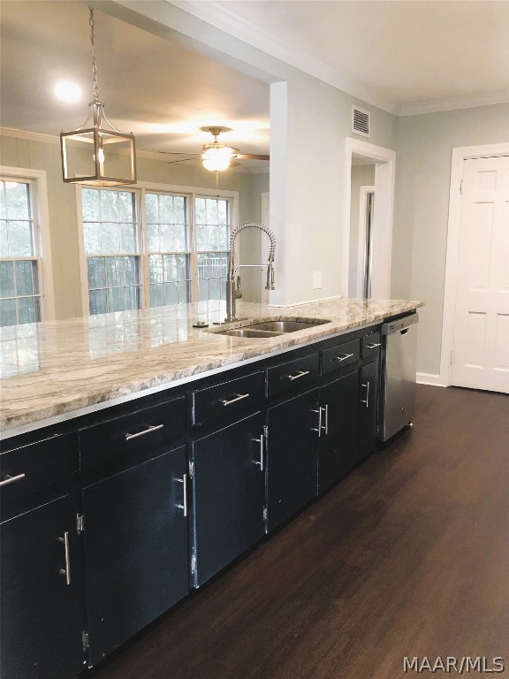 kitchen featuring pendant lighting, sink, stainless steel dishwasher, ornamental molding, and dark hardwood / wood-style flooring