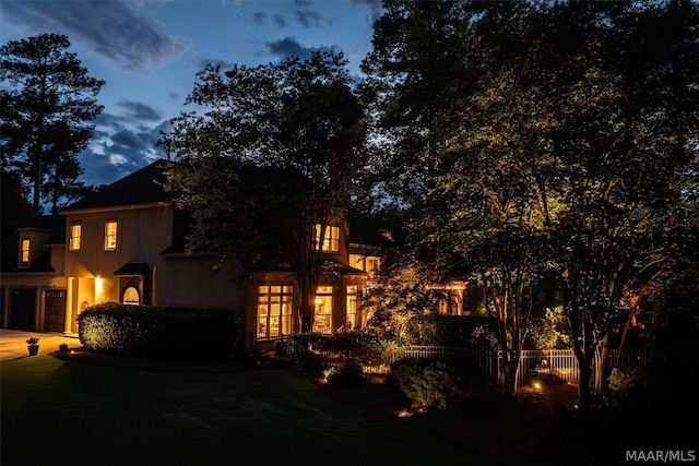 view of back house at dusk