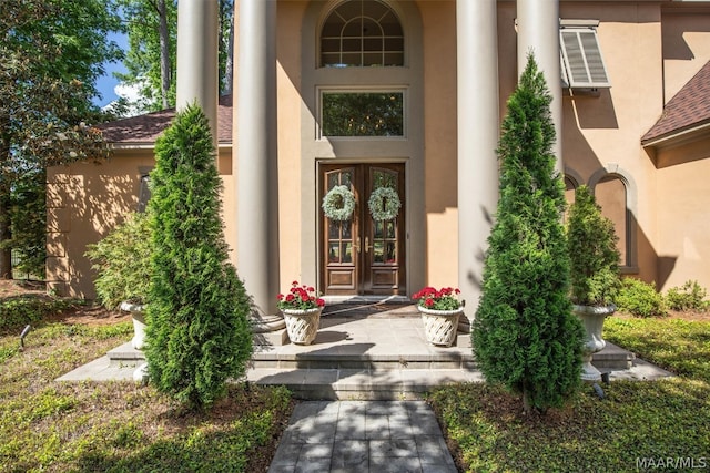 view of exterior entry with a wall mounted AC