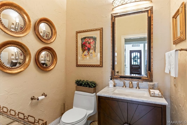 bathroom with toilet and vanity