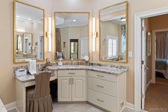 bathroom with crown molding, tile floors, and large vanity